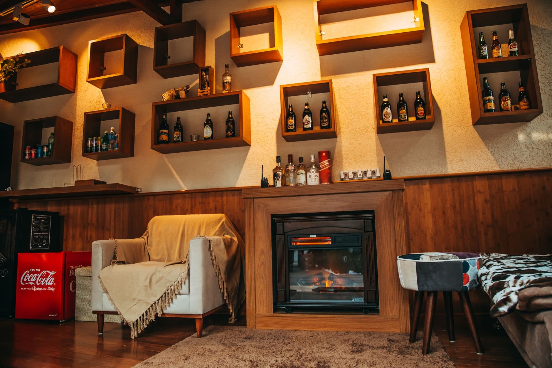Cozy living room interior with a stylish fireplace and decorative shelving.