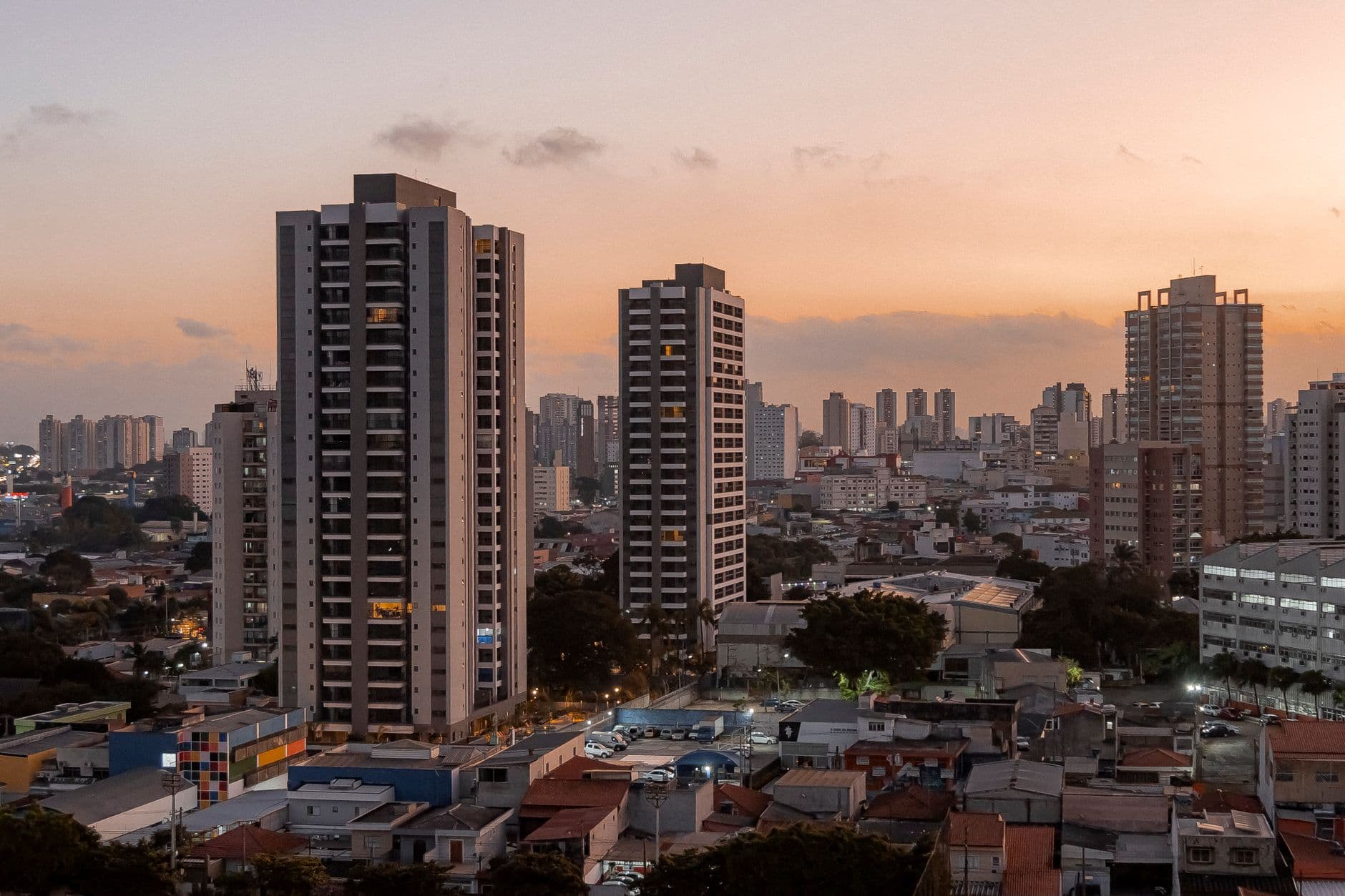 A stunning cityscape at sunset featuring towering high-rise buildings in an urban environment.